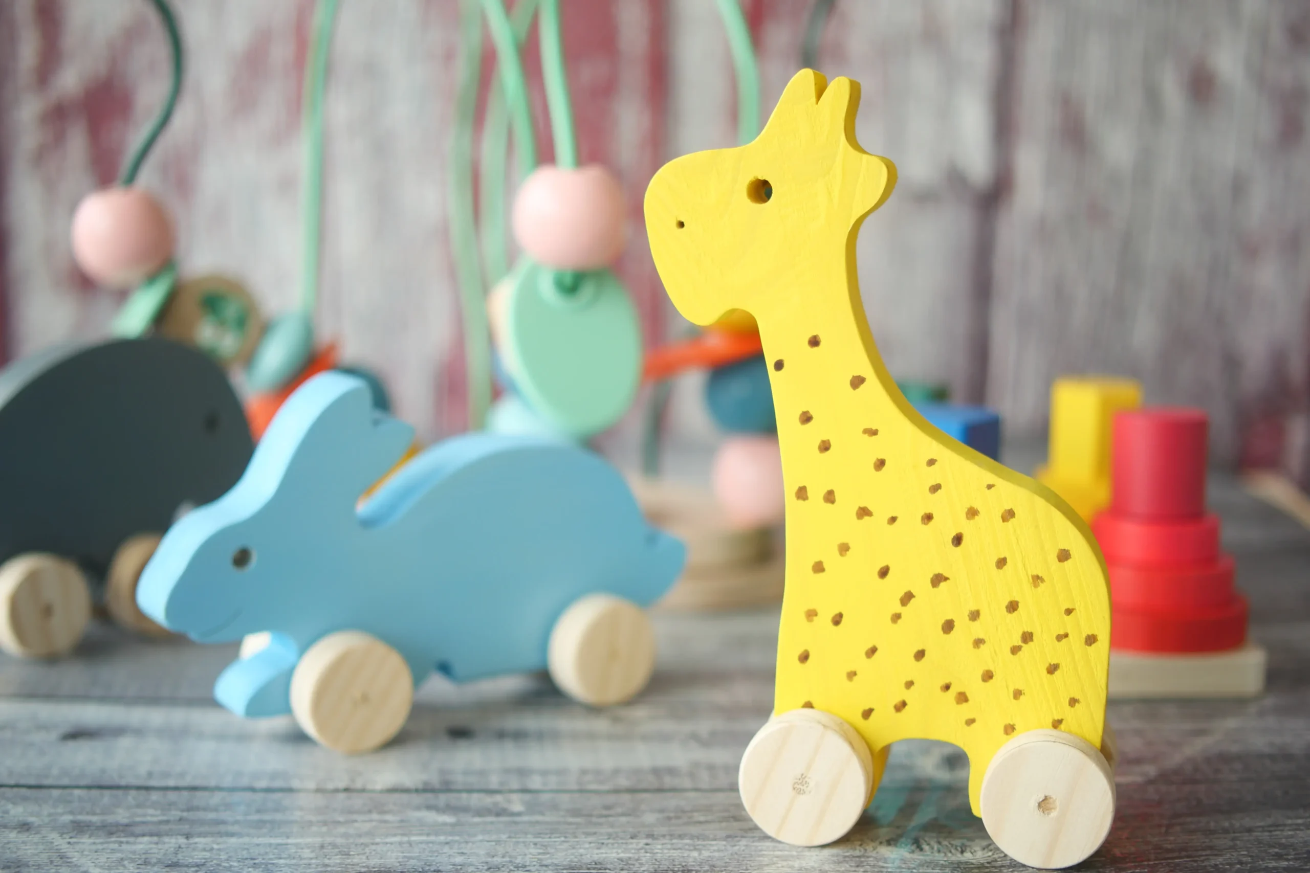 colorful-wooden-toys-on-rustic-grey-wooden-surface