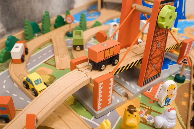 wooden-toy-city-scene-with-vehicles-crossing-a-bri